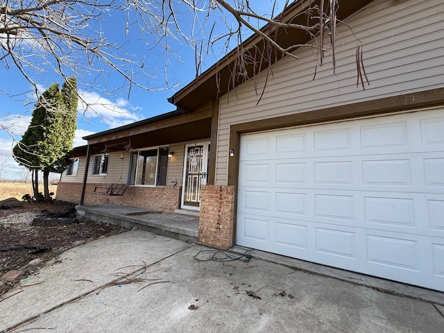 15183 Yale Rd, Lynn, MI 48097 - view of front of house with brick siding, driveway, and a porch