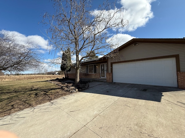15183 Yale Rd, Lynn, MI 48097 - single story home with a garage, brick siding, and driveway