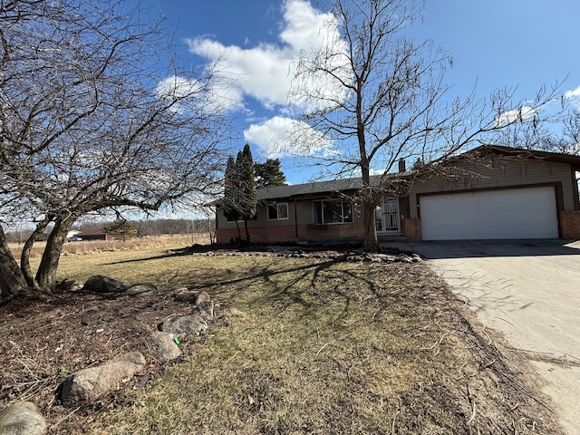 15183 Yale Rd, Lynn, MI 48097 - ranch-style home featuring concrete driveway, a front yard, brick siding, and a garage