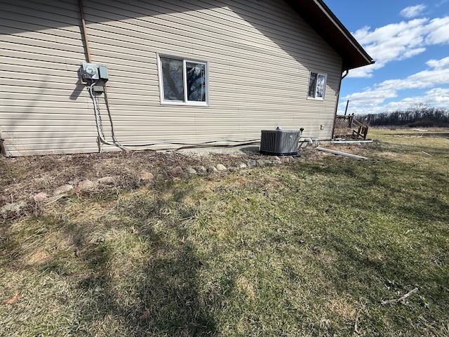 15183 Yale Rd, Lynn, MI 48097 - view of property exterior featuring central air condition unit and a yard