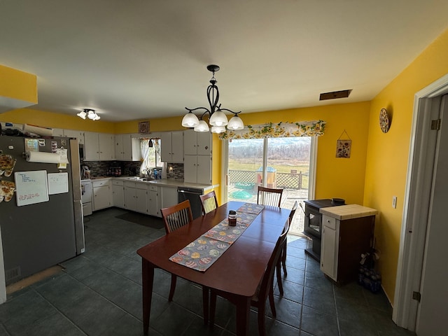 15183 Yale Rd, Lynn, MI 48097 - dining area featuring an inviting chandelier and dark tile patterned flooring