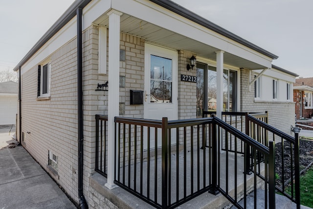 exterior space with a garage and brick siding