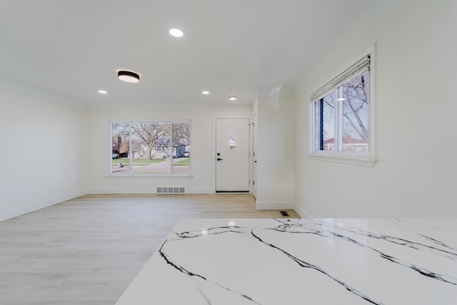 entryway featuring a healthy amount of sunlight, light wood-style flooring, visible vents, and recessed lighting