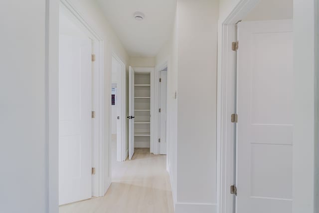 hallway featuring baseboards