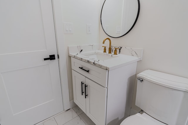 half bath with vanity, toilet, and marble finish floor