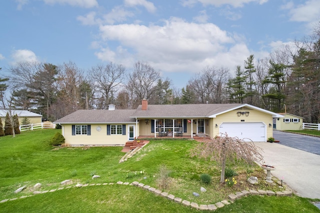 single story home with a chimney, driveway, fence, covered porch, and an attached garage