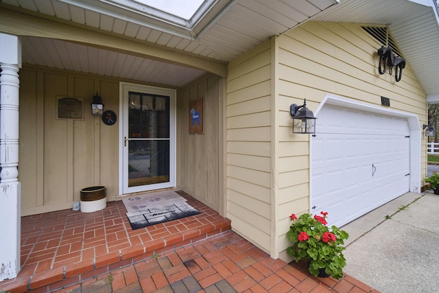 entrance to property featuring a porch and a garage