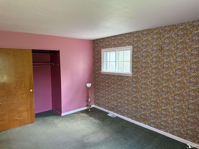 8367 S Douglas Rd, Bedford, MI 48144 - unfurnished bedroom with baseboards, carpet flooring, a closet, and wallpapered walls