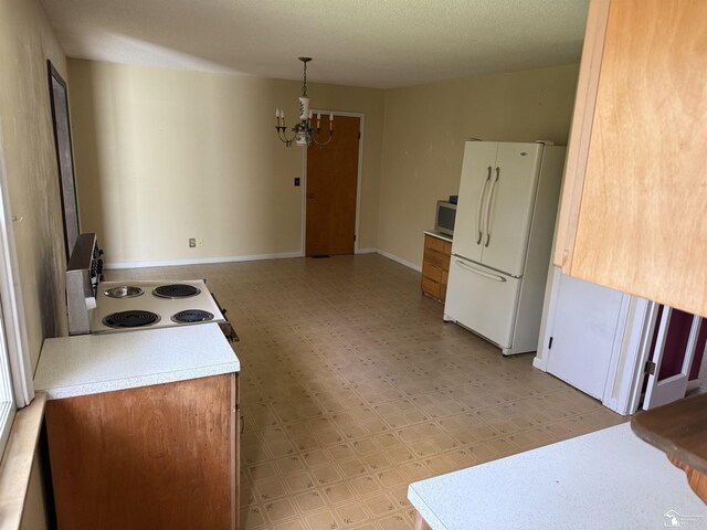 8367 S Douglas Rd, Bedford, MI 48144 - kitchen featuring freestanding refrigerator, light floors, electric range oven, light countertops, and a chandelier