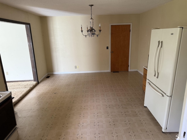 8367 S Douglas Rd, Bedford, MI 48144 - unfurnished dining area featuring baseboards, light floors, a chandelier, and visible vents