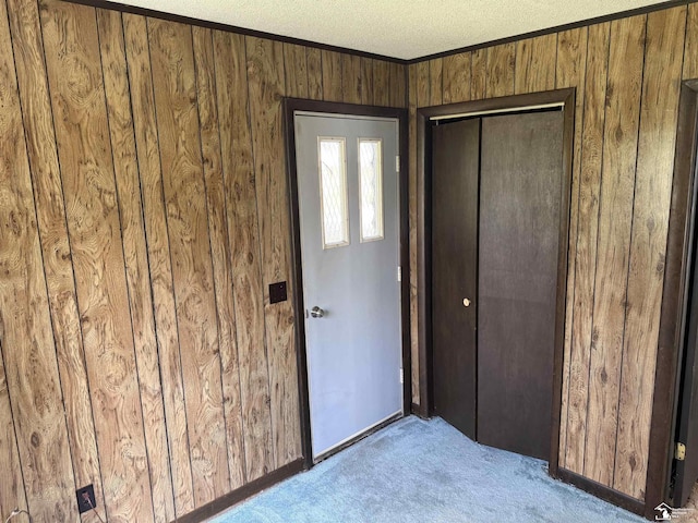 8367 S Douglas Rd, Bedford, MI 48144 - interior space with a textured ceiling, baseboards, ornamental molding, carpet flooring, and wood walls