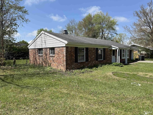8367 S Douglas Rd, Bedford, MI 48144 - view of front of property with a chimney, a front yard, brick siding, and fence