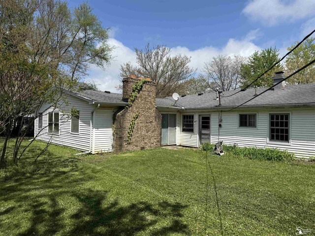 8367 S Douglas Rd, Bedford, MI 48144 - back of house with a chimney and a lawn