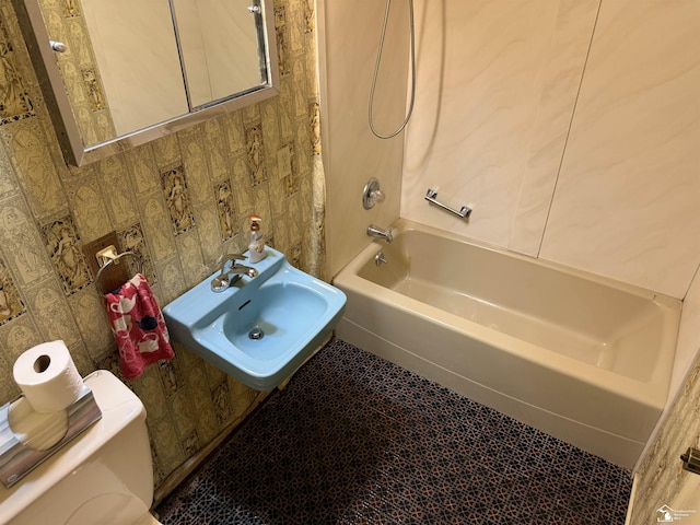 8367 S Douglas Rd, Bedford, MI 48144 - bathroom featuring toilet, shower / bathing tub combination, and a sink