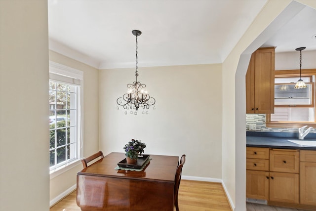 6572 Larme Ave, Allen Park, MI 48101 - dining area featuring an inviting chandelier, plenty of natural light, and baseboards
