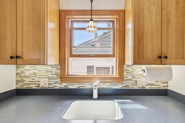 6572 Larme Ave, Allen Park, MI 48101 - kitchen with a sink, backsplash, hanging light fixtures, and dark countertops