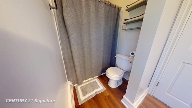 full bathroom featuring toilet, baseboards, and wood finished floors