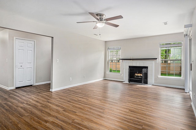 unfurnished living room with baseboards and wood finished floors