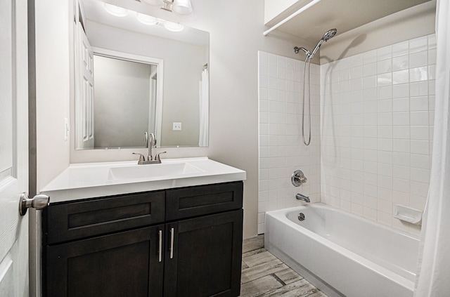 full bath with shower / bath combo, vanity, and wood finished floors