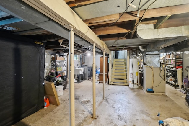 933 Cameron Ave, Pontiac, MI 48340 - unfinished below grade area with water heater, a sink, washing machine and clothes dryer, and stairway