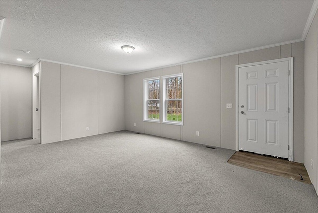interior space featuring ornamental molding, visible vents, and carpet