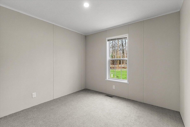 unfurnished room featuring recessed lighting, crown molding, visible vents, and carpet floors