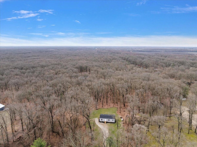 birds eye view of property with a forest view