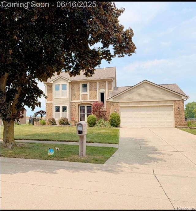 3335 Alderdale Dr, Sterling Heights, MI 48310 - traditional home featuring concrete driveway, an attached garage, a front lawn, and brick siding
