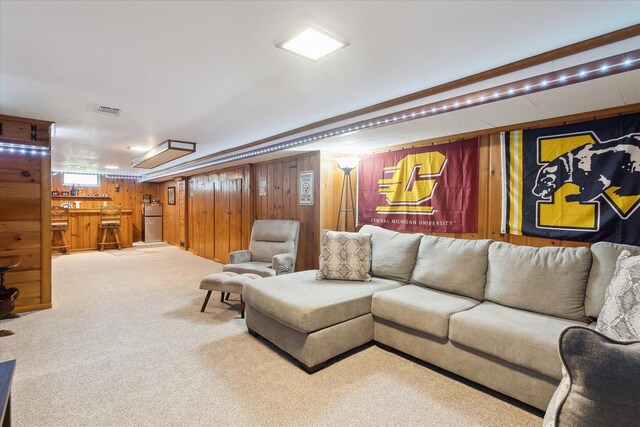 living room featuring bar area, carpet floors, and wooden walls