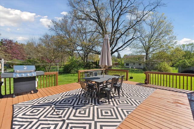 wooden terrace with area for grilling and outdoor dining area