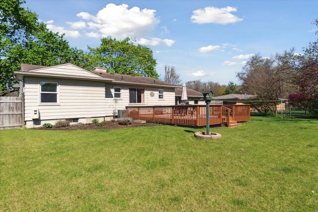 back of house featuring a deck, a chimney, and central AC