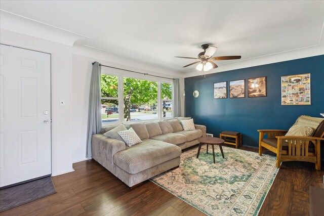 living area with a ceiling fan, dark wood-style floors, and baseboards