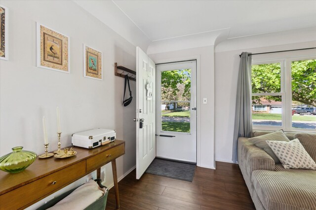 entryway with dark wood-style floors and baseboards