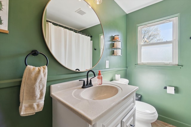 full bathroom featuring toilet, vanity, baseboards, and ornamental molding
