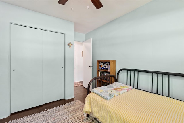 bedroom with a closet, wood finished floors, and a ceiling fan
