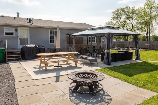 view of patio / terrace with outdoor dining space, a fire pit, fence, area for grilling, and a gazebo