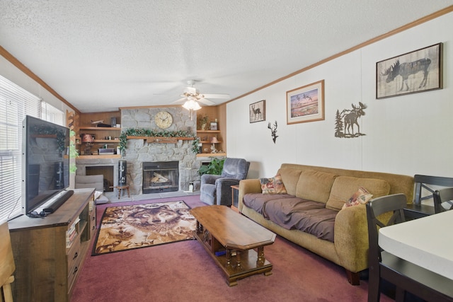 living area featuring carpet flooring, a ceiling fan, a fireplace, crown molding, and a textured ceiling