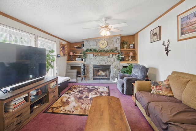 carpeted living room featuring ceiling fan, a textured ceiling, a fireplace, and ornamental molding