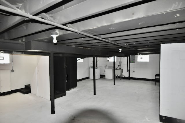 below grade area featuring washer / clothes dryer, electric panel, and a sink