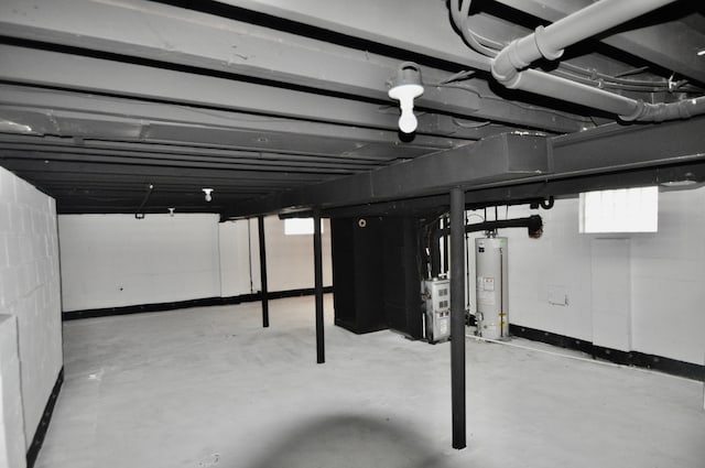 below grade area featuring water heater and baseboards