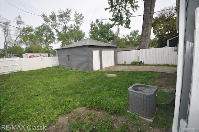 23027 Powell Ave, Hazel Park, MI 48030 - view of yard with central air condition unit, a garage, an outdoor structure, and driveway