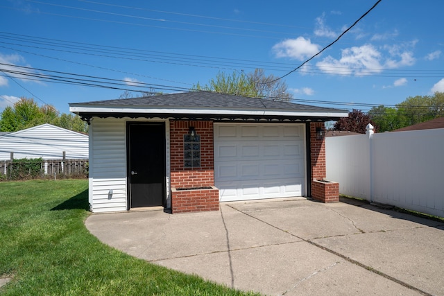 detached garage with concrete driveway
