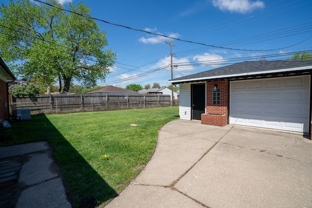 view of yard with driveway, a detached garage, central air condition unit, and an outdoor structure