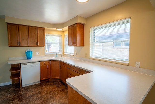 kitchen with white dishwasher, a sink, brown cabinetry, a peninsula, and light countertops