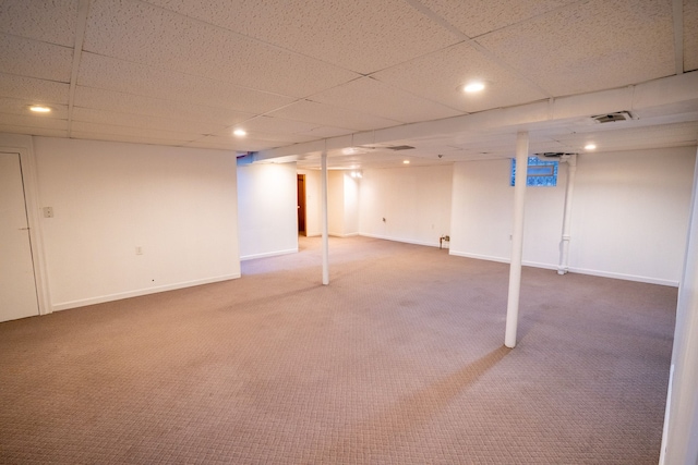 finished below grade area with carpet floors, baseboards, a drop ceiling, and recessed lighting