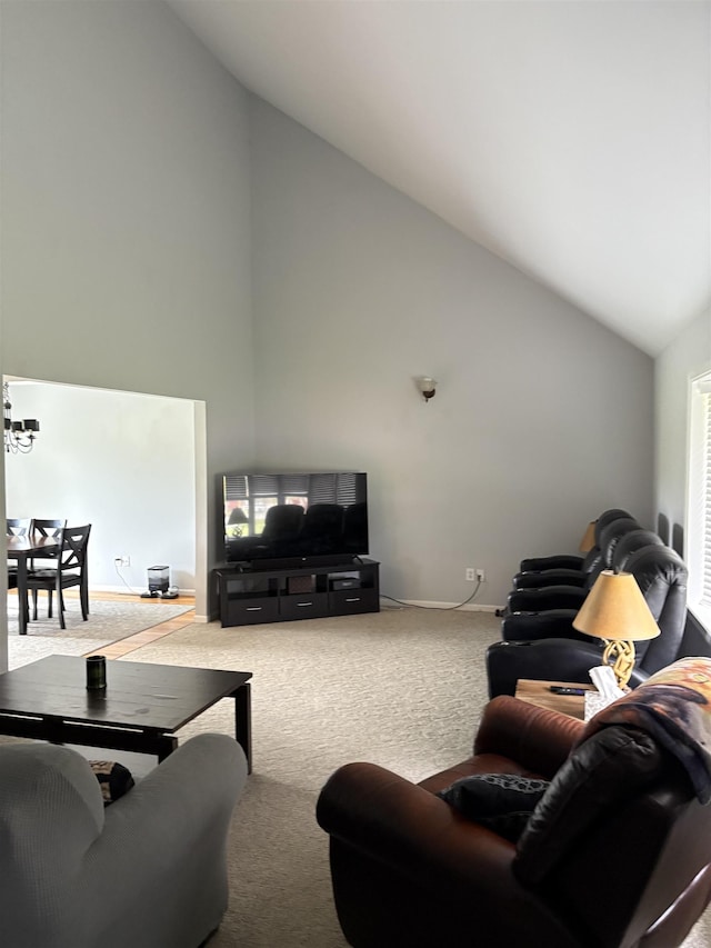 carpeted living room featuring baseboards and high vaulted ceiling