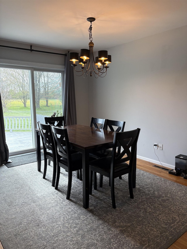 3470 Seymour Rd, Swartz Creek, MI 48473 - dining space with a chandelier and wood finished floors
