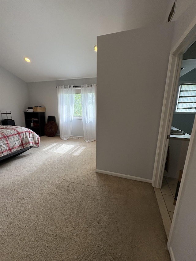 bedroom featuring baseboards, multiple windows, light carpet, and recessed lighting
