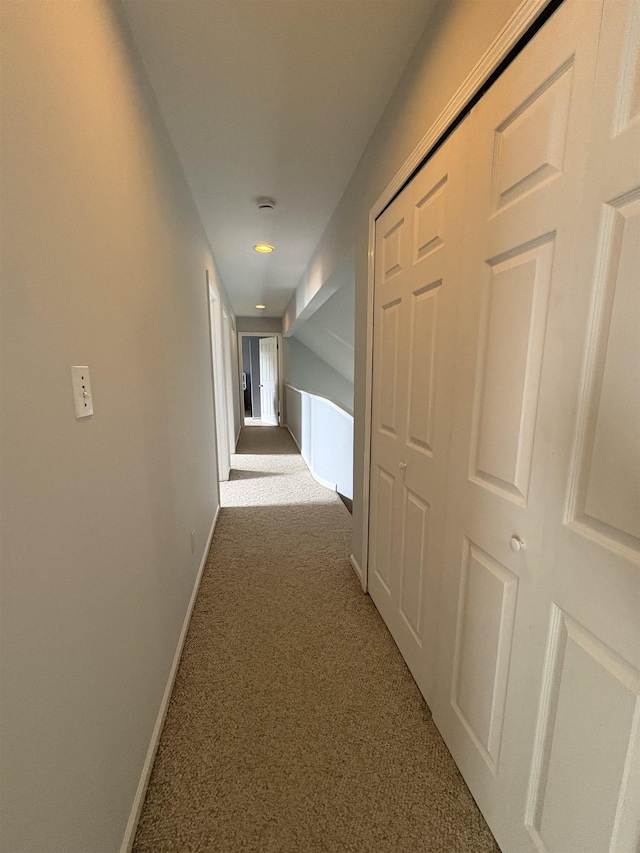 hallway featuring carpet flooring, baseboards, and recessed lighting