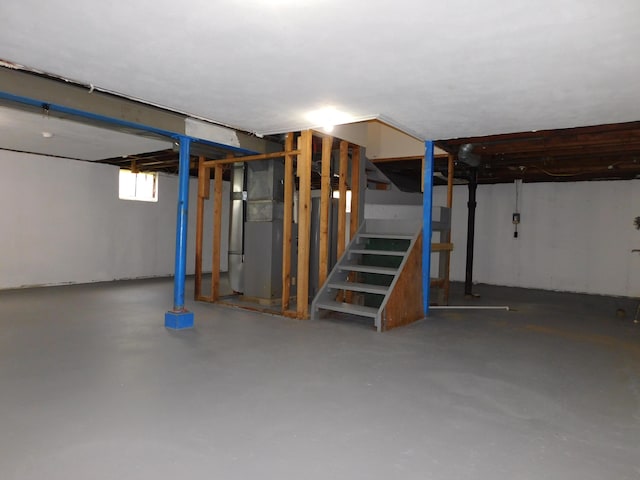 below grade area with stairs and heating unit
